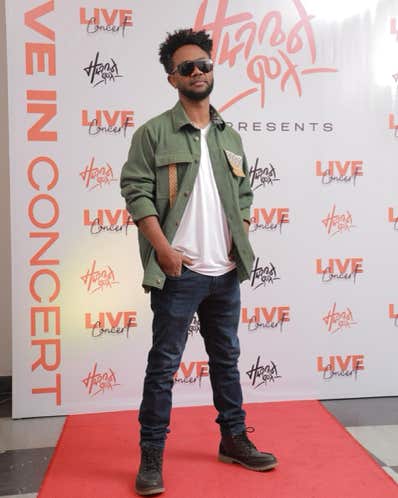 Zeruabbel Molla posing on a red carpet at a concert event.