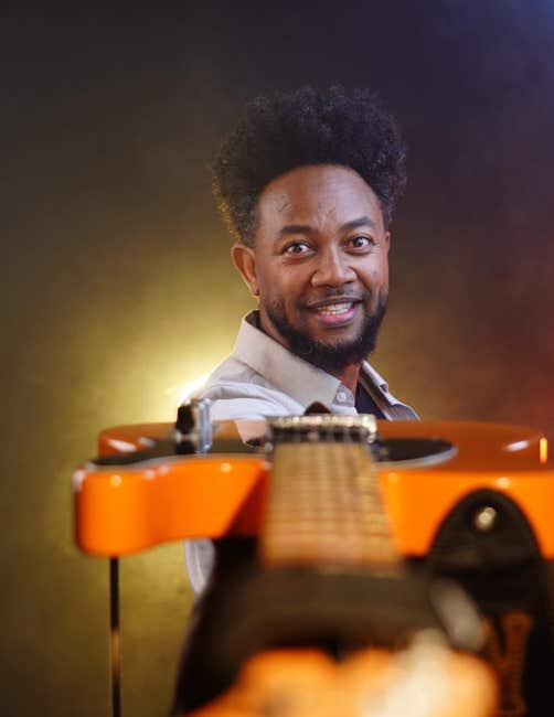 Zeruabbel Molla with an electric guitar.